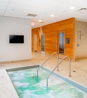 Indoor hot tub and spa area at Coast at Lakeshore East apartments in Chicago. Relaxing and luxurious amenities