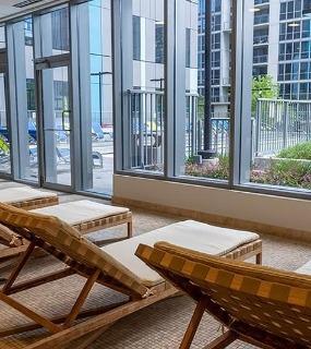 Indoor lounge chairs near the pool at Coast at Lakeshore East apartments in Chicago