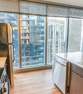 Kitchen with city views at Coast at Lakeshore East apartments in Chicago.