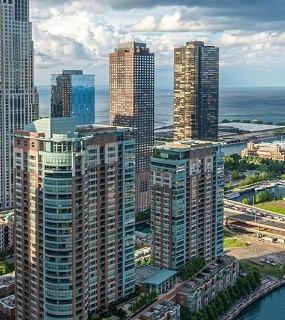 Lake Michigan and skyline view from Coast at Lakeshore East apartments in Chicago. Ferris wheel and waterfront