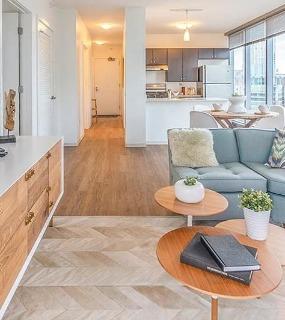 Modern living room with city views at Coast at Lakeshore East apartments in Chicago