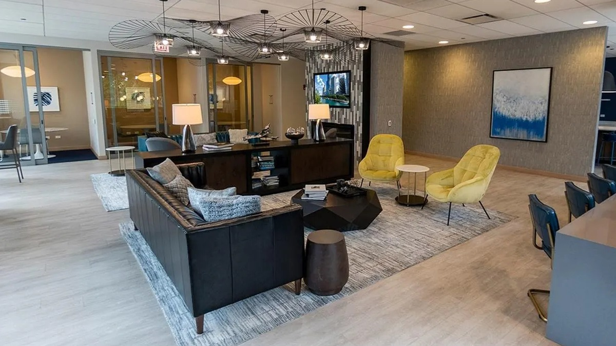 A spacious and cozy lounge area at Coast at Lakeshore East with stylish lighting, comfortable seating, and a collaborative desk