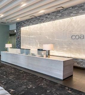 Stylish and modern lobby at Coast at Lakeshore East apartments in Chicago. Features contemporary design and comfortable seating