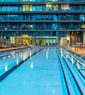 Outdoor pool at night at Coast at Lakeshore East apartments in Chicago
