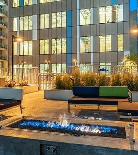 Outdoor terrace with fire pit and grilling stations at Coast at Lakeshore East apartments in Chicago. Social gathering spot