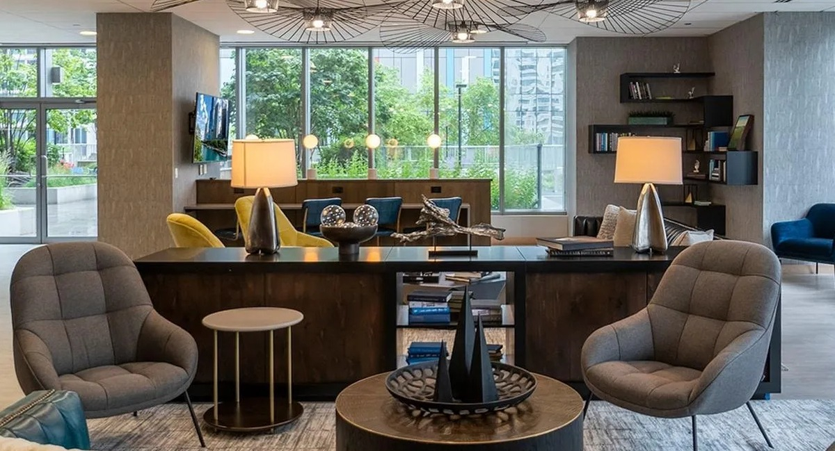 A sophisticated resident lounge at Coast at Lakeshore East, featuring plush seating, unique lighting, and a relaxing ambiance