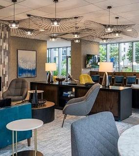 Resident lounge with fireplace and modern decor at Coast at Lakeshore East apartments in Chicago