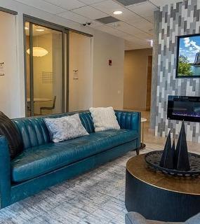 Resident lounge with TV and modern furnishings at Coast at Lakeshore East apartments in Chicago