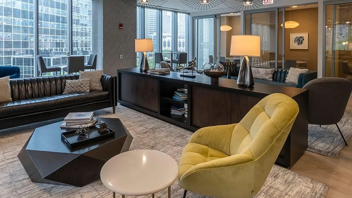 A stylish resident lounge at Coast at Lakeshore East with comfortable seating, modern lighting, and ample workspace