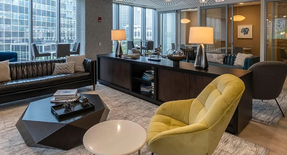 A stylish resident lounge at Coast at Lakeshore East with comfortable seating, modern lighting, and ample workspace