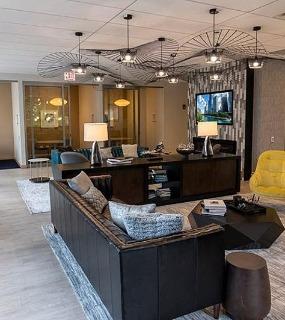 Stylish resident lounge with modern furniture at Coast at Lakeshore East apartments in Chicago. Comfortable and social space