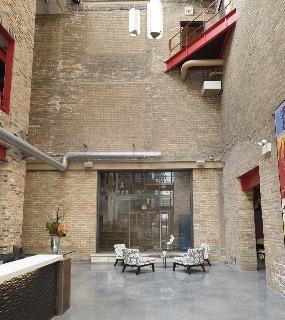 Exterior view of Cobbler Square Lofts, featuring a historic brick facade in a prime Chicago location