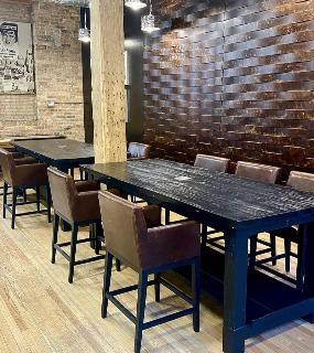 Modern dining area with a sleek table, stylish chairs, and warm lighting at Cobbler Square Lofts in Chicago