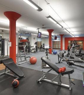 Well-equipped fitness center with cardio machines and strength equipment at Cobbler Square Lofts in Chicago
