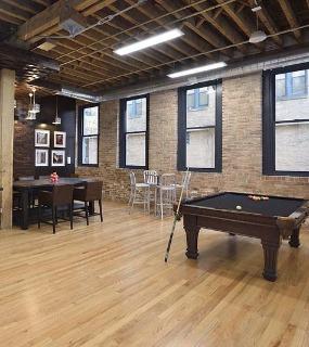 Modern gaming lounge with entertainment options and comfortable seating at Cobbler Square Lofts in Chicago
