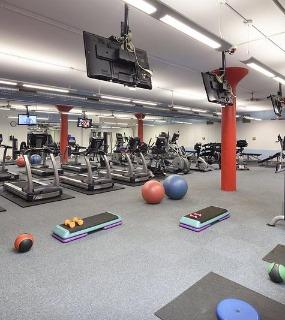 Fully equipped gym with weights, treadmills, and strength machines at Cobbler Square Lofts in Chicago