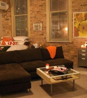 Cozy living area with modern furniture, stylish décor, and soft lighting at Cobbler Square Lofts in Chicago