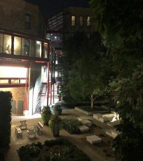 Green park area surrounding Cobbler Square Lofts, providing a peaceful outdoor retreat in Chicago