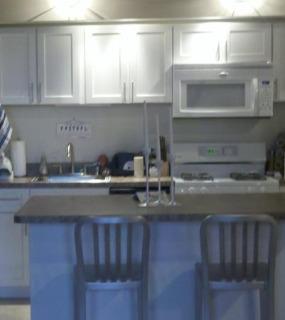 Stylish kitchen with contemporary finishes, spacious countertops, and ample storage at Cobbler Square Lofts in Chicago