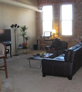 Stylish living room with contemporary furnishings, warm lighting, and a cozy atmosphere at Cobbler Square Lofts in Chicago