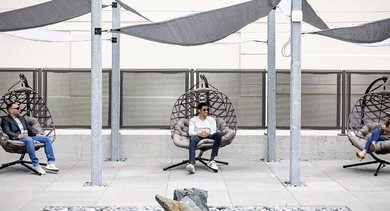 Modern outdoor patio in stylish swing chairs at Coeval Apartments in Chicago