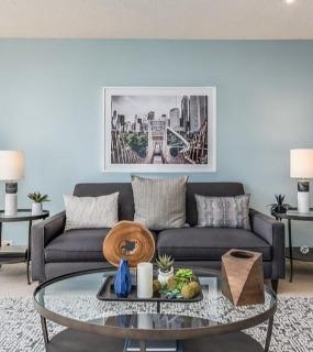 Bright living room with large windows, modern decor, and stunning city views at Columbus Plaza