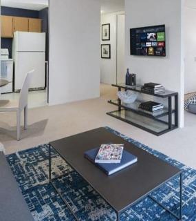Studio apartment with a cozy living area, dining space, and a bedroom featuring modern decor at Columbus Plaza