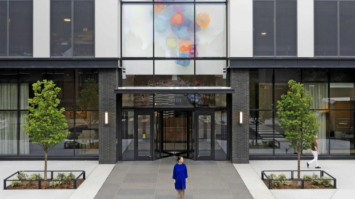 Modern exterior and main entrance of Coppia apartments in Chicago, featuring unique architectural design and artwork