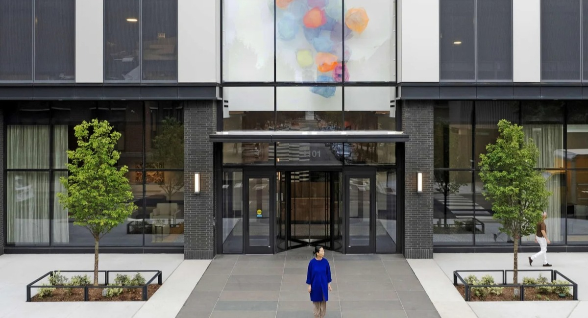 Modern exterior and main entrance of Coppia apartments in Chicago, featuring unique architectural design and artwork