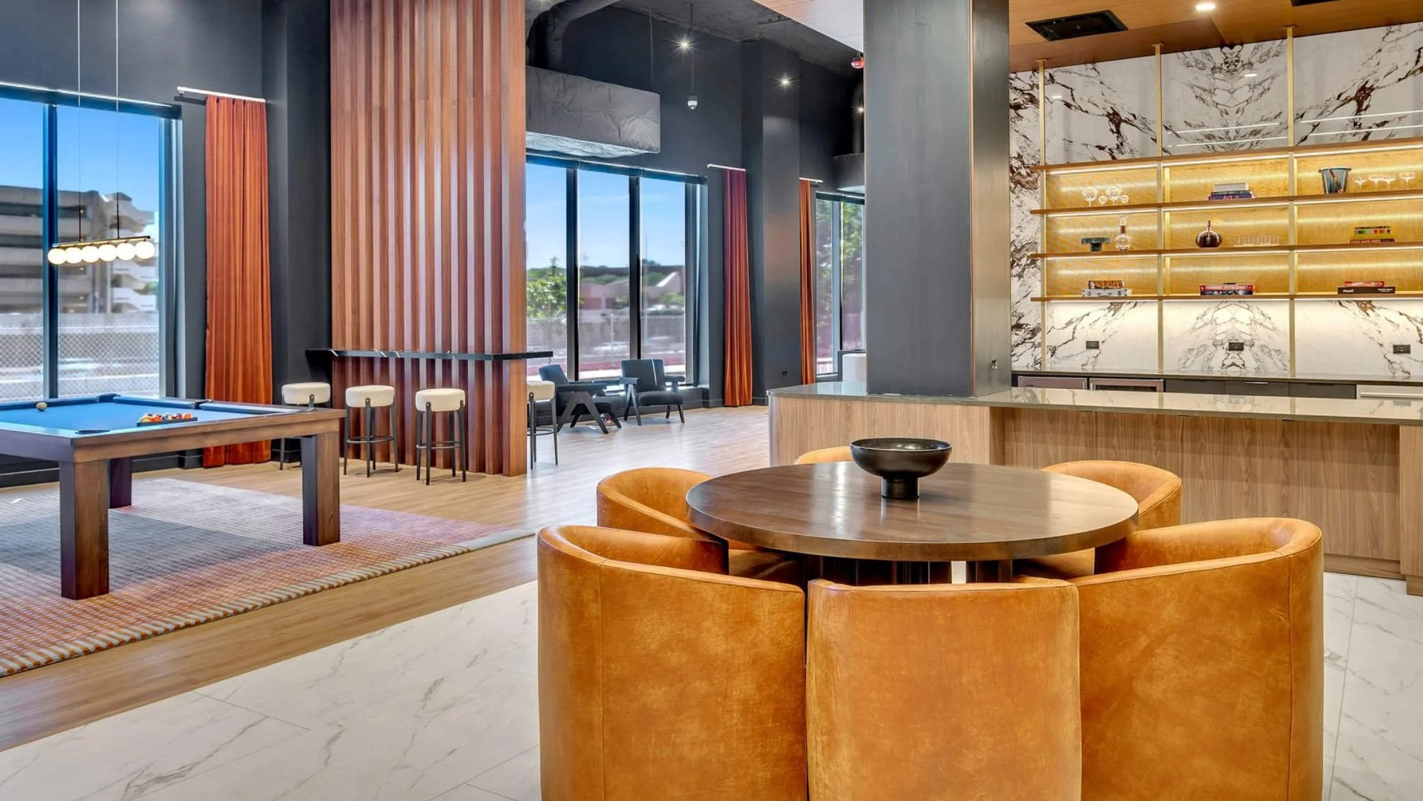 Chic game room and bar area at Coppia apartments in Chicago, featuring a pool table and stylish seating