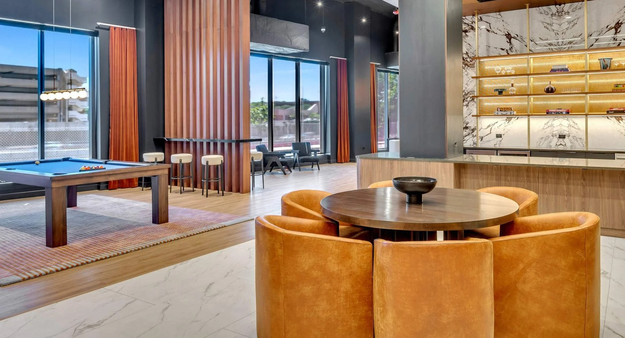 Chic game room and bar area at Coppia apartments in Chicago, featuring a pool table and stylish seating