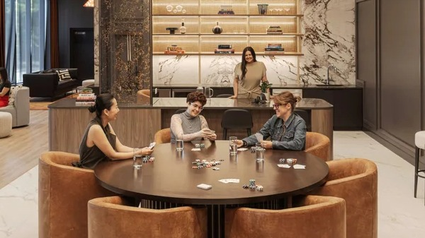 Vibrant game room at Coppia apartments in Chicago, featuring a card table and a stylish bar area for residents