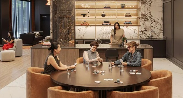 Vibrant game room at Coppia apartments in Chicago, featuring a card table and a stylish bar area for residents