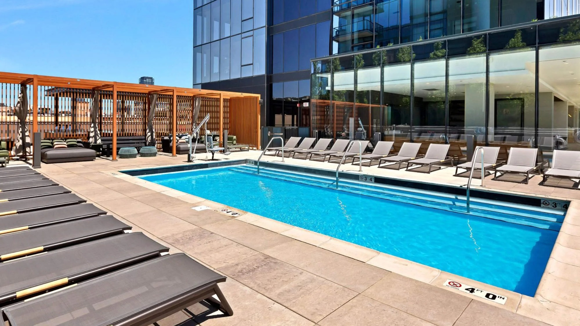 Beautiful outdoor swimming pool and lounge area at Coppia apartments in Chicago, perfect for relaxation