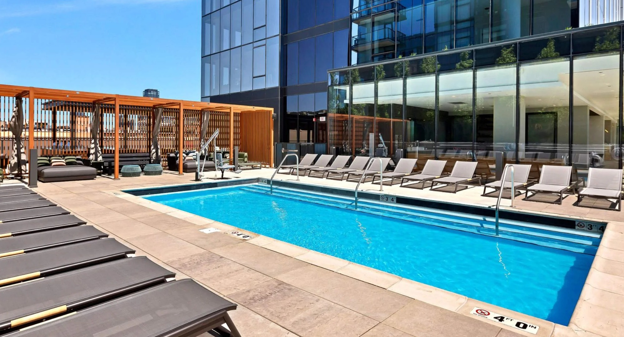 Beautiful outdoor swimming pool and lounge area at Coppia apartments in Chicago, perfect for relaxation