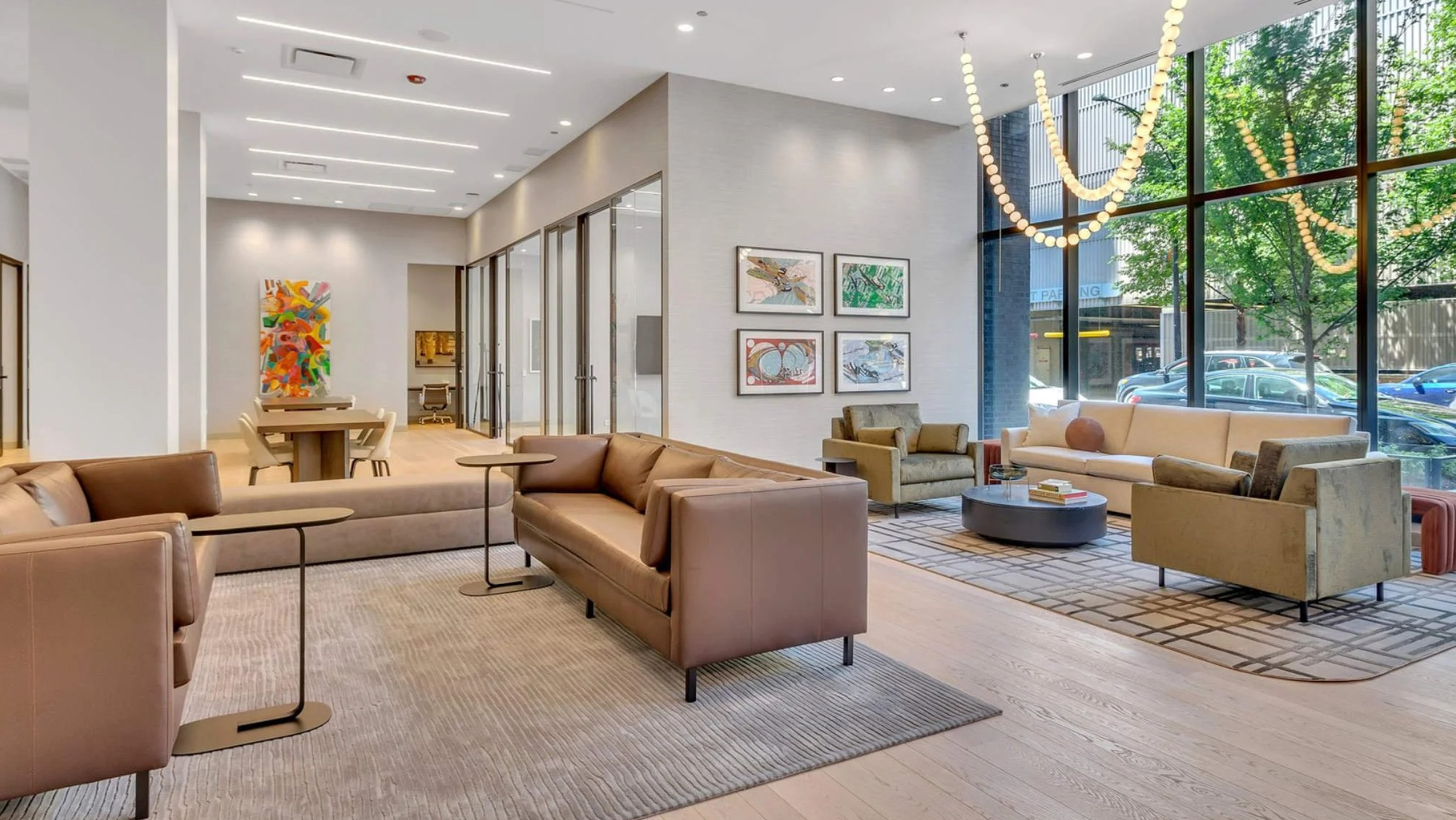 Modern resident lounge and social area at Coppia apartments in Chicago, featuring comfortable seating and large windows