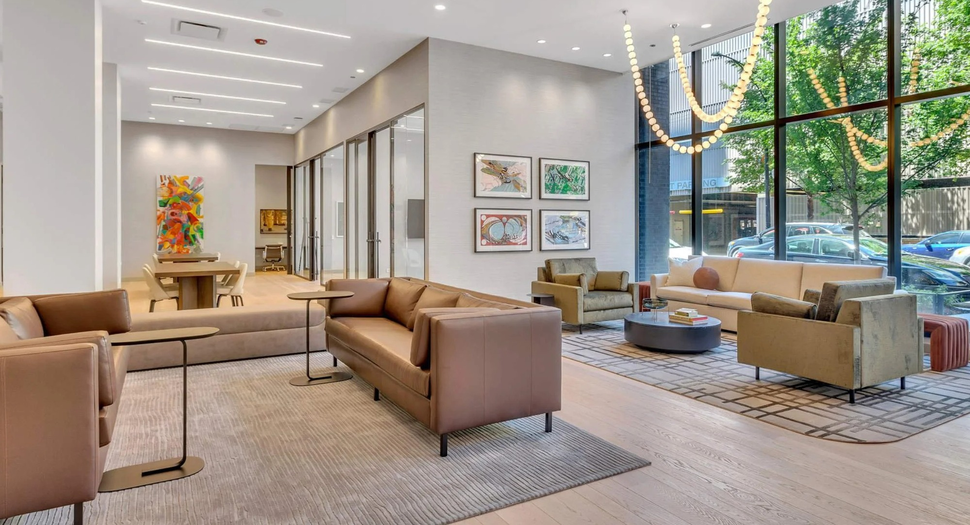 Modern resident lounge and social area at Coppia apartments in Chicago, featuring comfortable seating and large windows