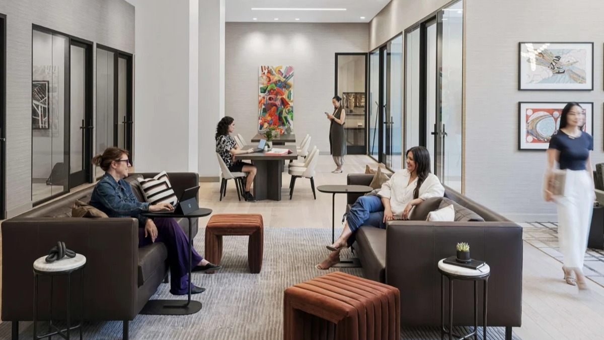 Spacious resident lounge and co-working space at Coppia apartments in Chicago, with comfortable seating and tables
