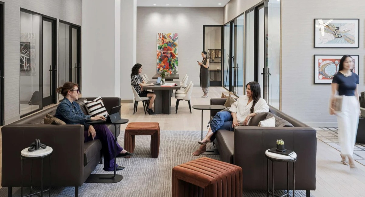 Spacious resident lounge and co-working space at Coppia apartments in Chicago, with comfortable seating and tables