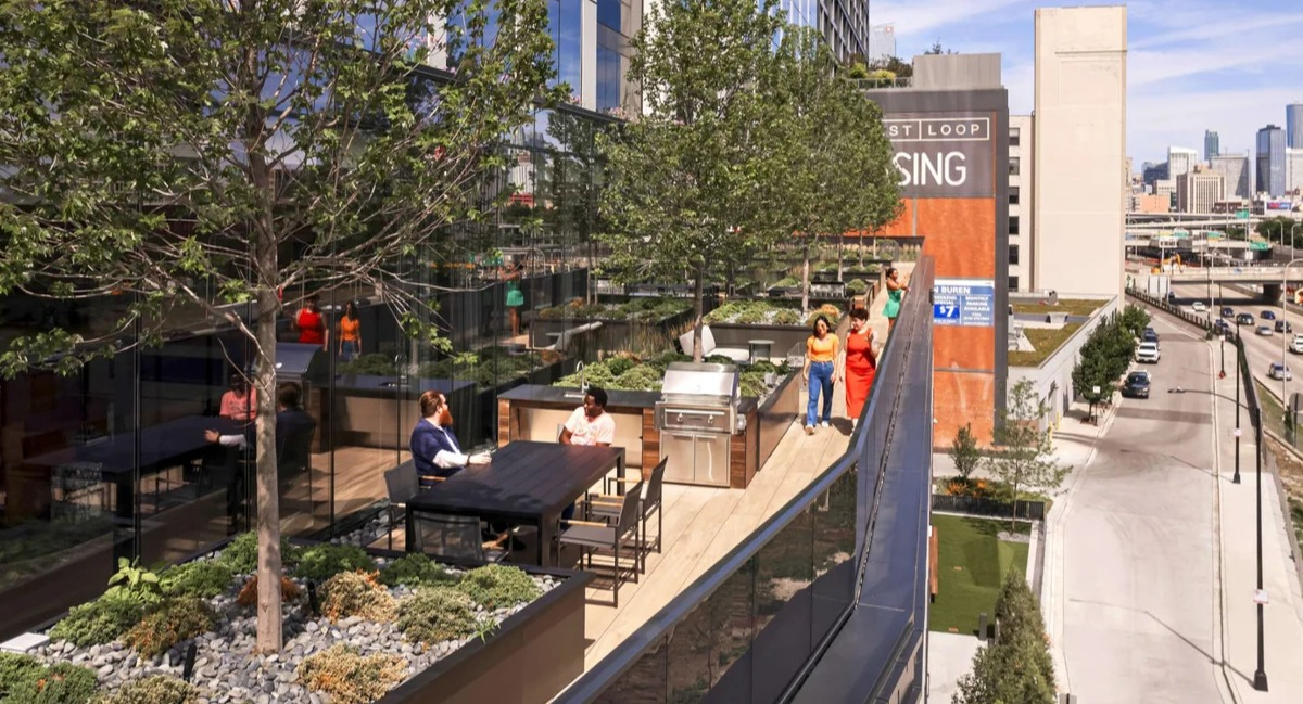 Expansive rooftop terrace at Coppia apartments in Chicago with outdoor seating, green spaces, and city views