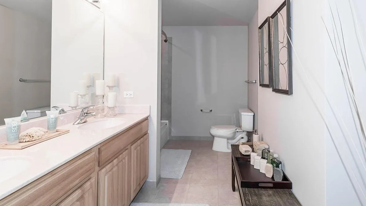 Spacious bathroom featuring a double vanity, large mirror, and a shower-tub combination at Echelon at K Station in Chicago