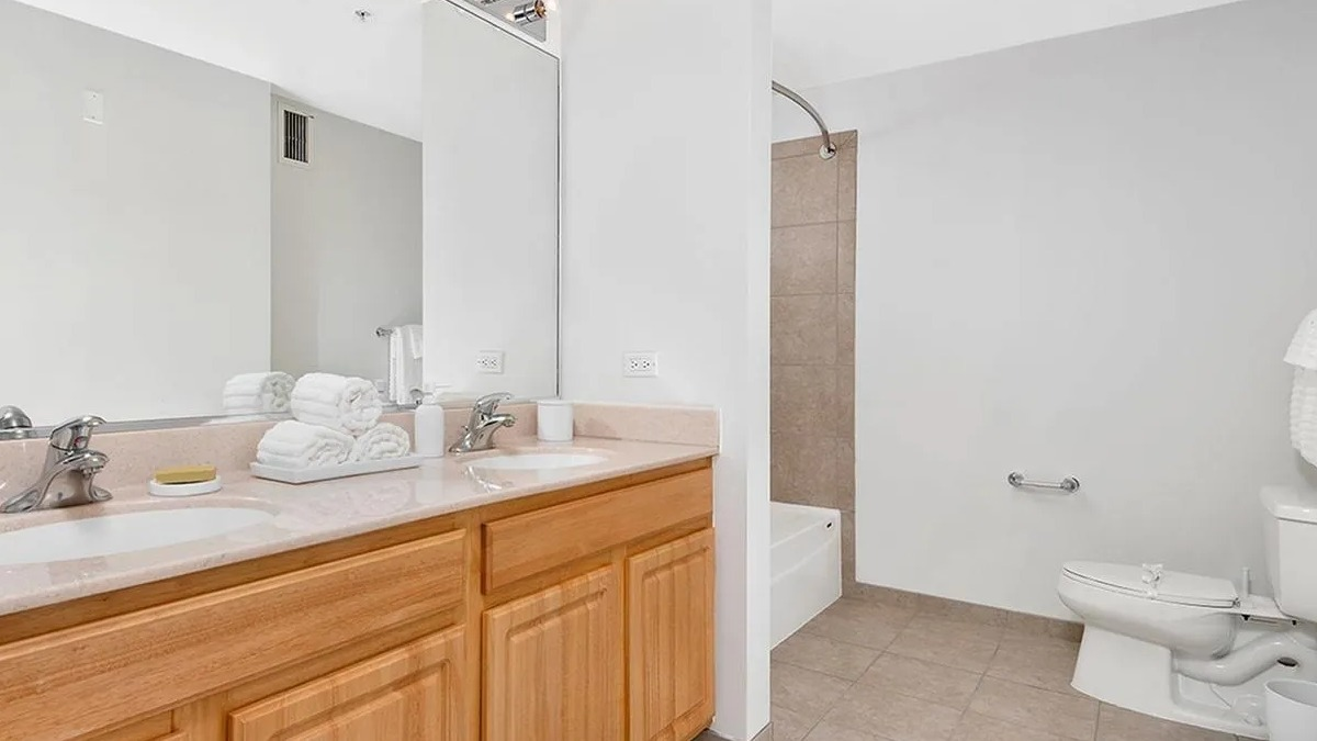 Spacious bathroom with a double vanity, ample counter space, and a shower-tub combination at Echelon at K Station in Chicago