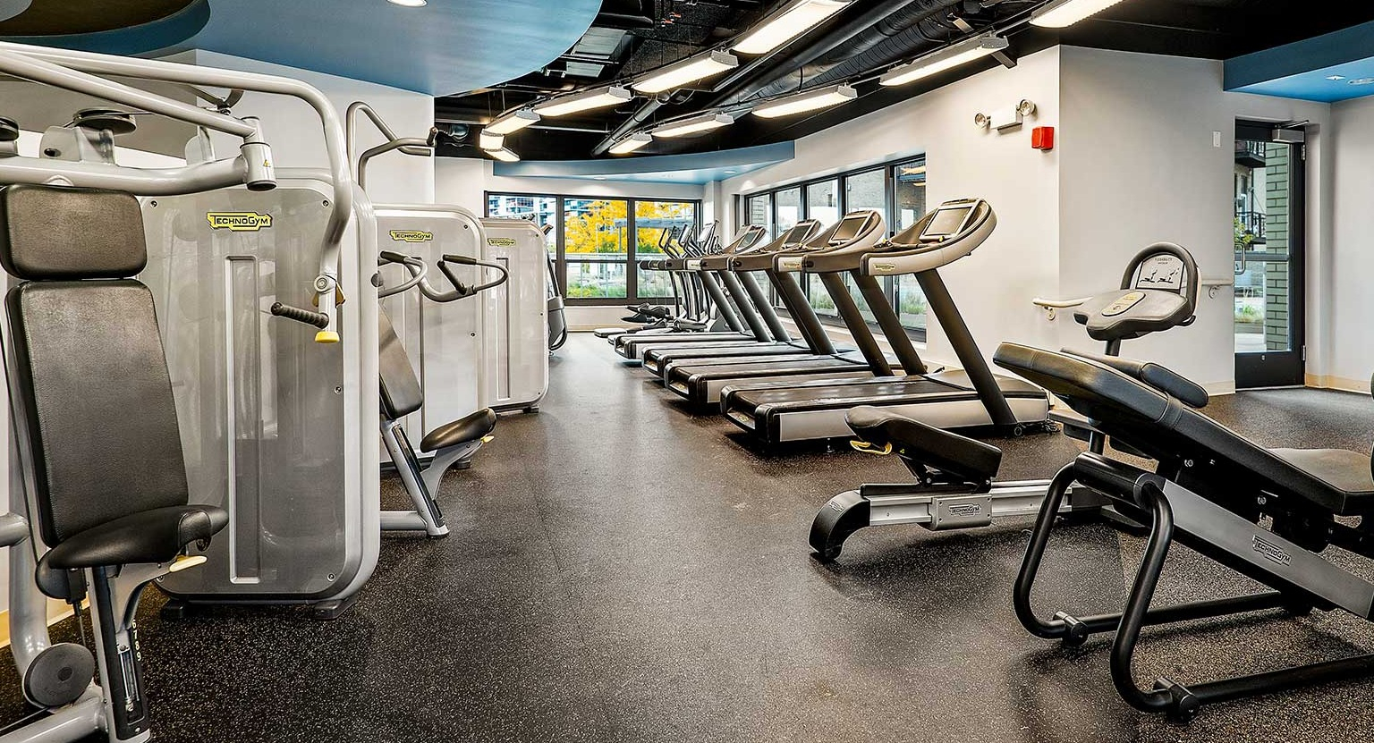 State-of-the-art fitness center with a variety of cardio machines and strength training equipment, at Eleven Thirty apartments in Chicago