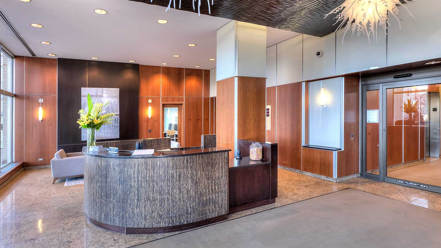 Elegant and spacious lobby with a welcoming concierge desk, modern decor, and comfortable seating at Eleven Thirty apartments in Chicago