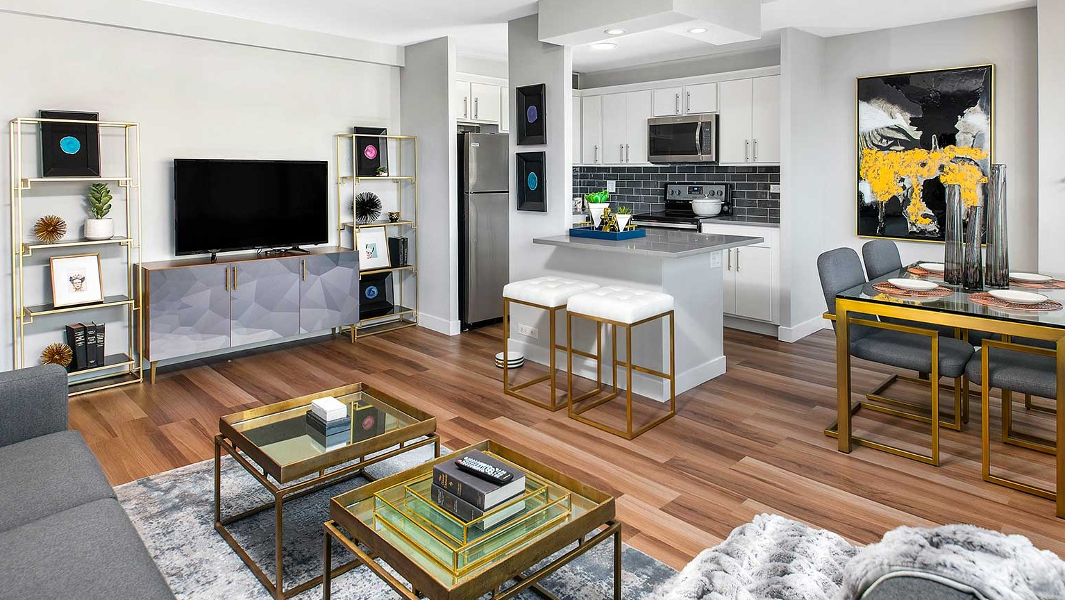 Spacious open-concept living and dining area with modern decor, hardwood floors, and a well-appointed kitchen at Eleven Thirty in Chicago