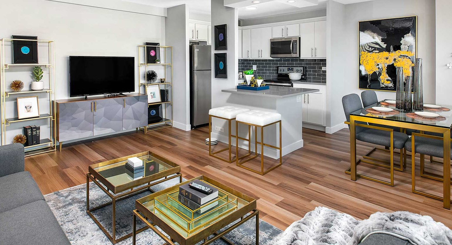 Spacious open-concept living and dining area with modern decor, hardwood floors, and a well-appointed kitchen at Eleven Thirty in Chicago