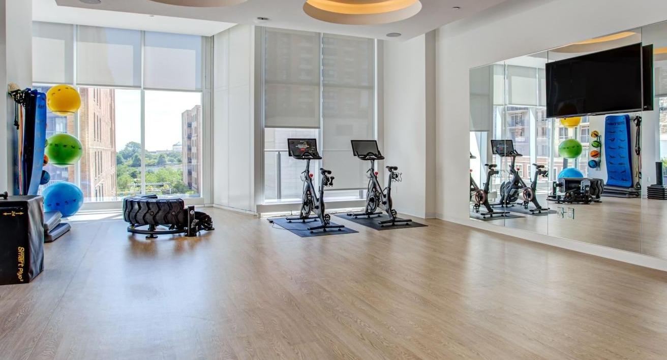 Versatile fitness studio with spin bikes, open floor space for yoga, and functional training equipment at Eleven40 apartments in Chicago