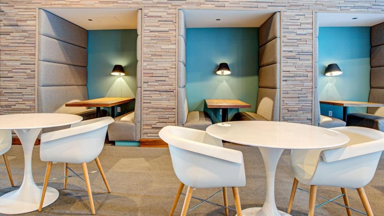 Dedicated co-working space featuring private work pods and communal tables, ideal for productivity at Eleven40 apartments in Chicago