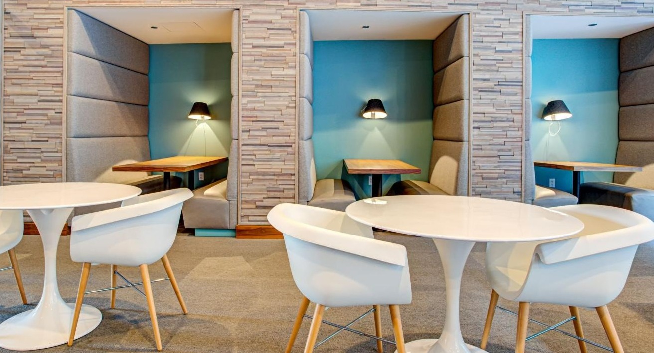 Dedicated co-working space featuring private work pods and communal tables, ideal for productivity at Eleven40 apartments in Chicago