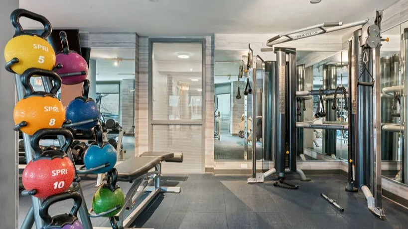 Fitness center area with a colorful kettlebell rack and strength training equipment at Elm Street Plaza Chicago